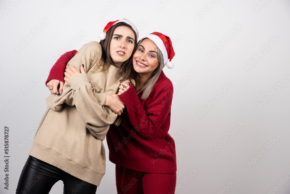 Two scared young girls dressed in warm sweaters looking at camera and screaming Two scared young girls dressed in warm sweaters looking at camera and screaming