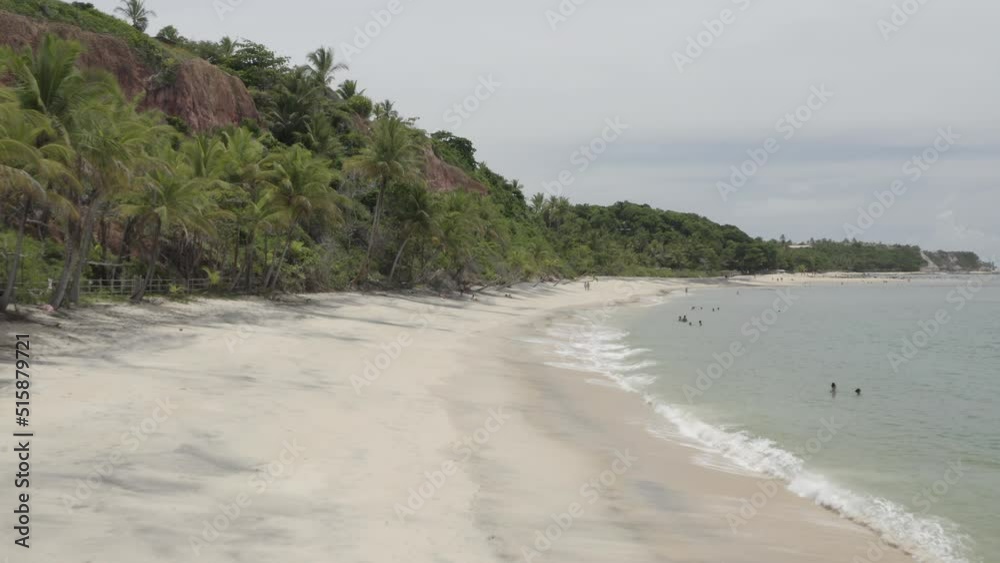 Drone shot of people walking on the beach at mid-day. Praia do Espelho, Bahia, Brazil. D-LOG. Drone shot of people walking on the beach at mid-day. Praia do Espelho, Bahia, Brazil. D-LOG.