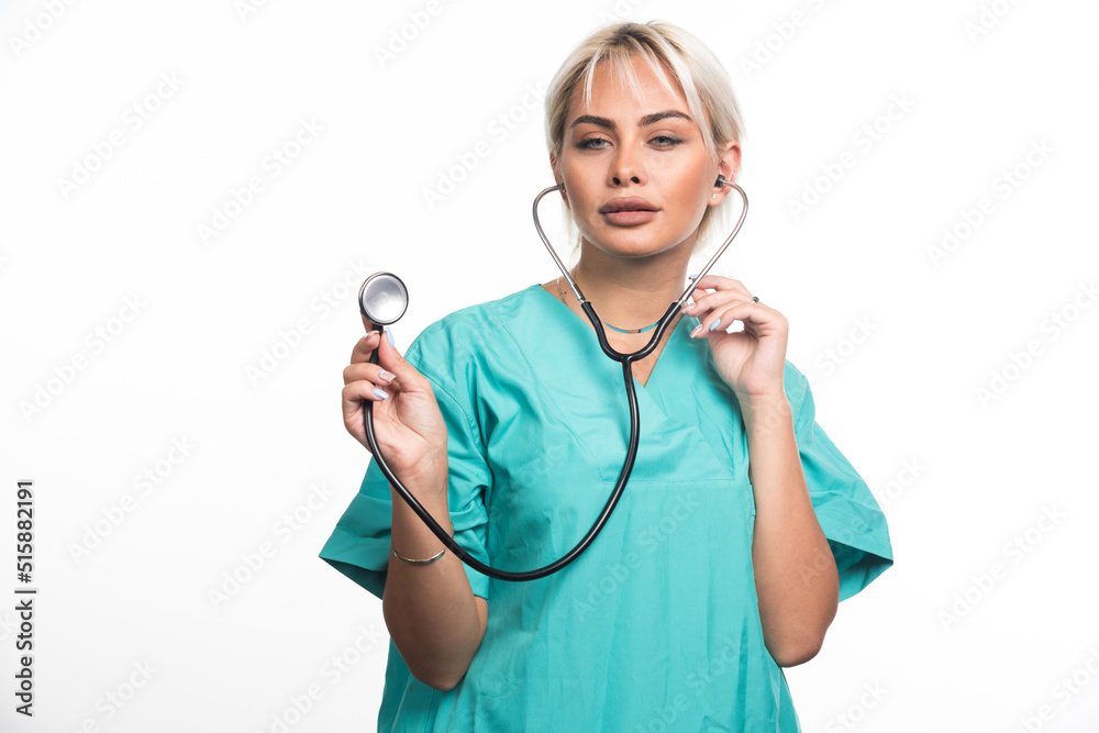 Female doctor using stethoscope on white background Female doctor using stethoscope on white background