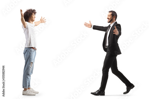 Full length profile shot of a casual guy with curly hairstyle waiting to hug a businessman