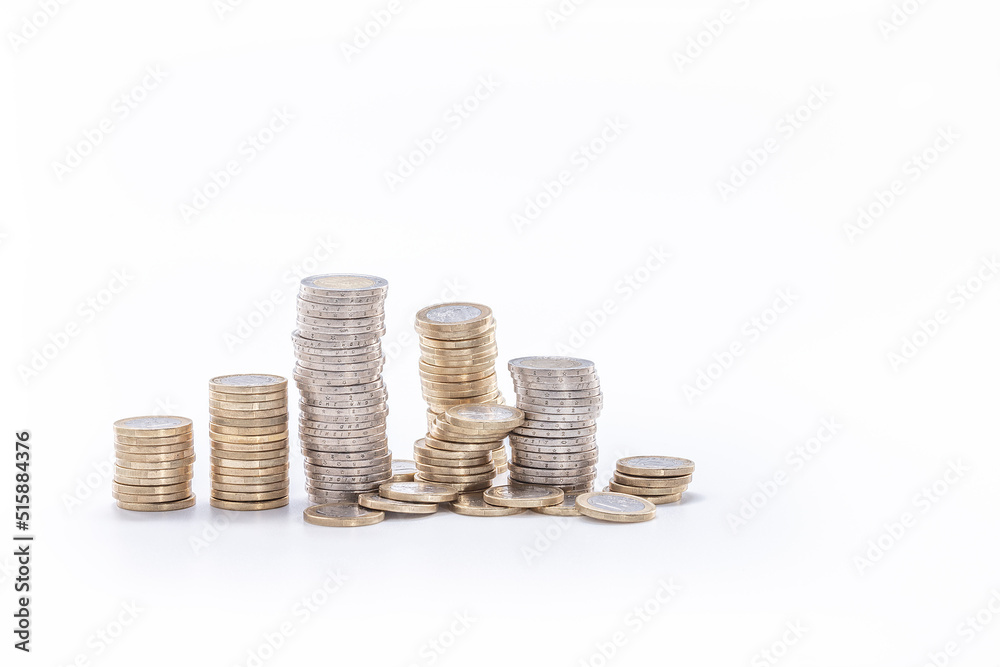 abundance of money, columns of one and two euro coins on a white background abundance of money, columns of one and two euro coins on a white background