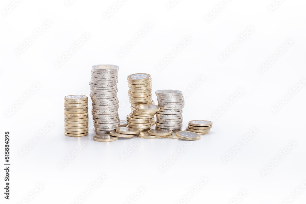 abundance of money, columns of one and two euro coins on a white background abundance of money, columns of one and two euro coins on a white background