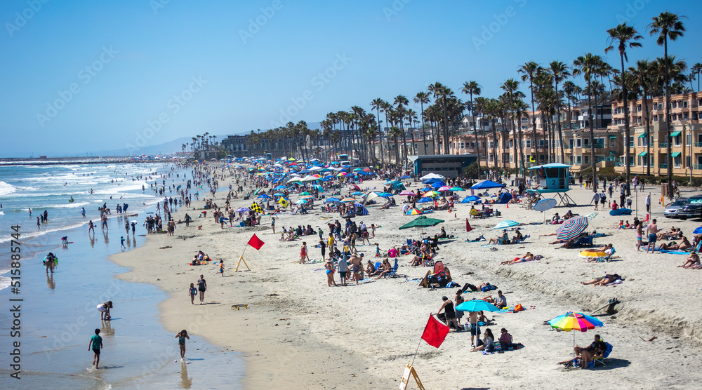 The Beach at Oceanside, California, Crowded with People on Vacation enjoying the Shore The Beach at Oceanside, California, Crowded with People on Vacation enjoying the Shore