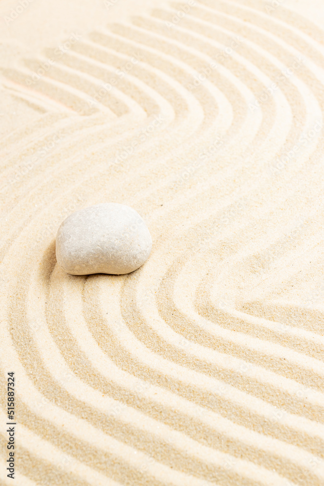 Obraz premium zen garden meditation stone background. Stones and lines in the sand for the balance of relaxation and harmony of spirituality or spa health. Natural colors