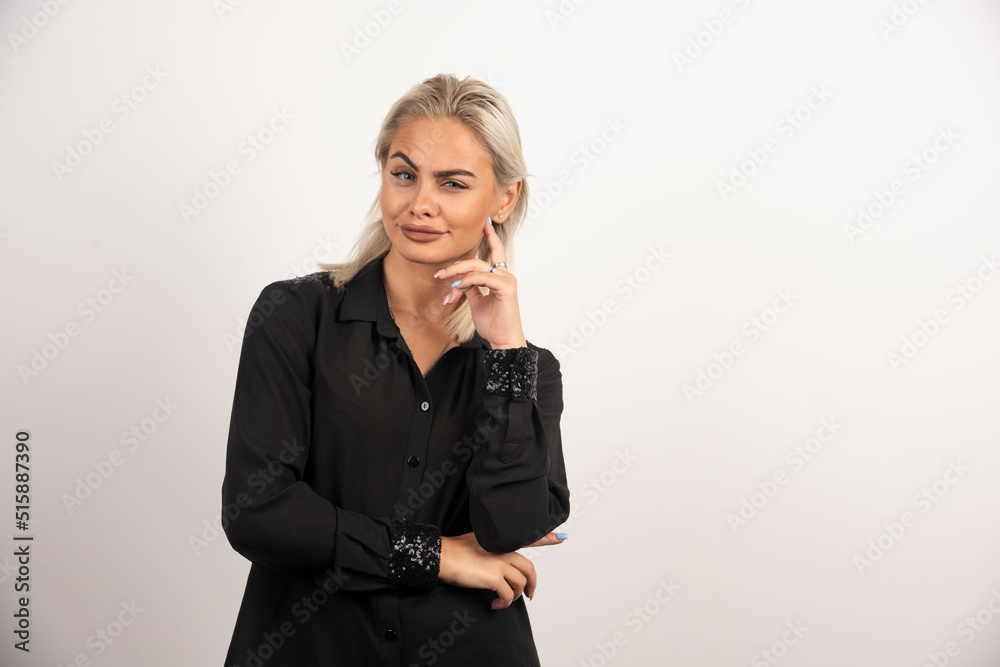 Portrait of smiling woman in black shirt posing on white background Portrait of smiling woman in black shirt posing on white background