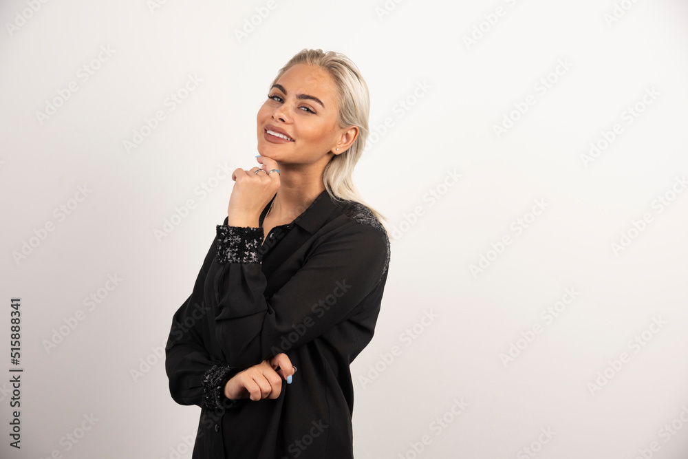 Smiling woman in black shirt posing on white background Smiling woman in black shirt posing on white background