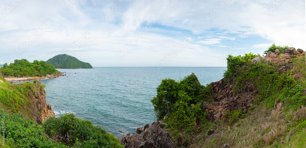 Fototapeta premium A beautiful viewpoint of the sea and a tropical island with cliffs and rocks at Noen Nang Phaya Viewpoint at Chalerm Burapha Chonlathit Highway, Chanthaburi, Thailand, panorama.