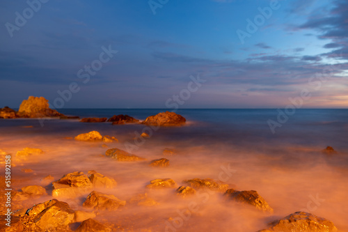 Beautiful sunset on the coast of Khao Nang Phaya  sea water hitting rocks  soft focus  Chanthaburi  Thailand.
