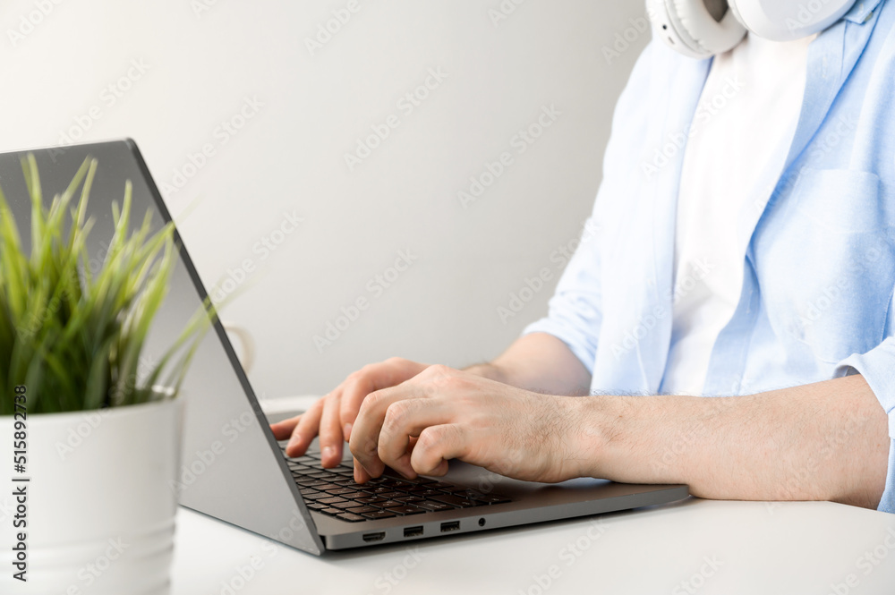 Fototapeta premium Closeup of unrecognizable man typing on laptop. Working or online education