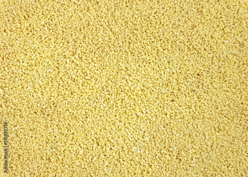 Yellow Soy lecithin granules top view. dietary supplements. Healthy nutrition concept. Soy Bean Lecithin with Plastic Spoon close up. photo