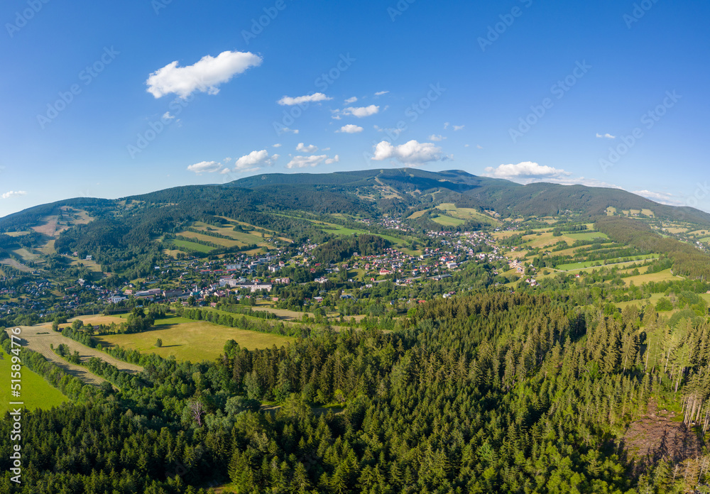 Aerial photo of city in middle of mountains