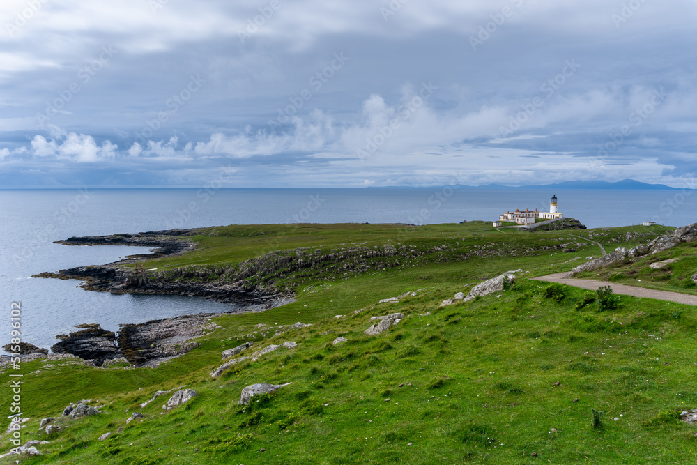 the Neist Point Lighthouse on the green cliffs of the Isle of Skye