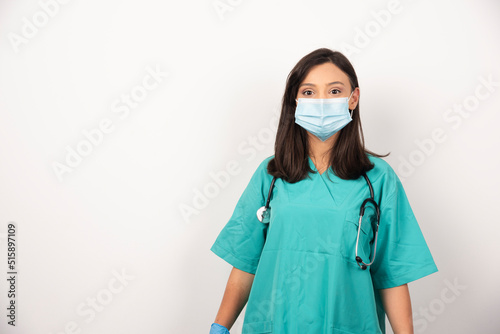 Female doctor in mask and stethoscope on white background