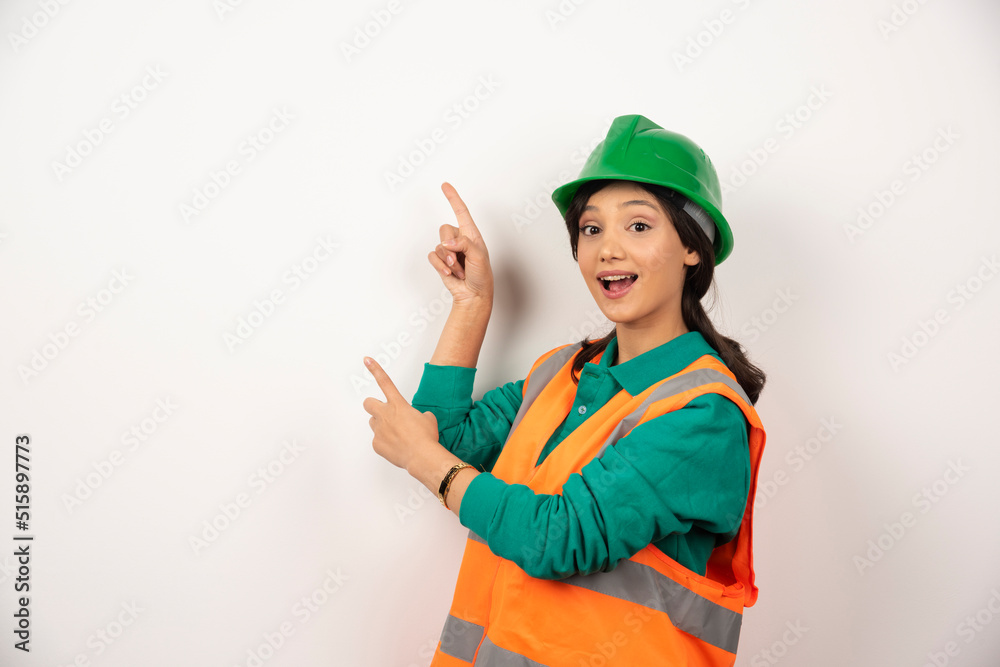Female industrial engineer in uniform with helmet on white background Female industrial engineer in uniform with helmet on white background