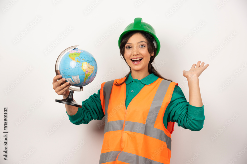 Female firefighter with globe feeling happy on white background Female firefighter with globe feeling happy on white background