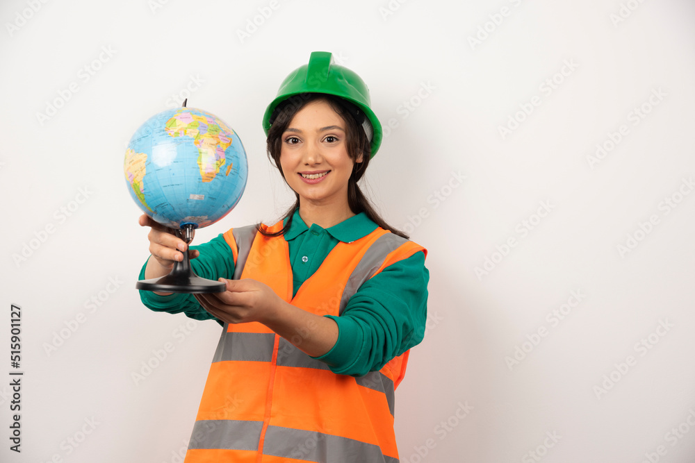 Female firefighter pointing globe on white background Female firefighter pointing globe on white background
