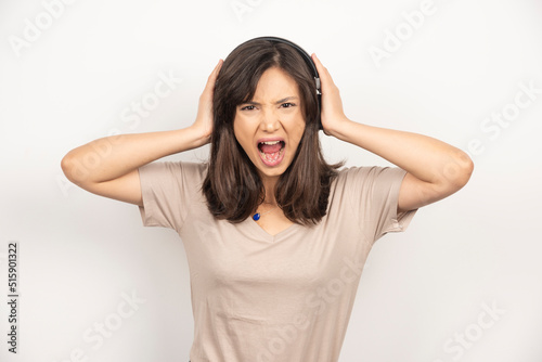 Young woman getting angry on white background