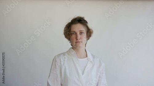 Zoom in of young modern confident successful business woman with short hair take professional photo portrait in studio. Female in casual shirt, sit, look at camera on white background. Startup concept