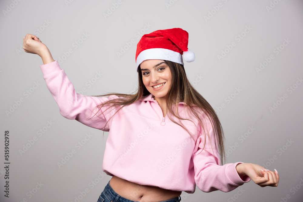 A happy woman in Santa Claus red hat posing A happy woman in Santa Claus red hat posing