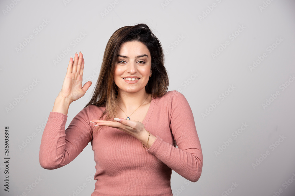 Smiling woman showing open hand palm with copy space for product or text Smiling woman showing open hand palm with copy space for product or text