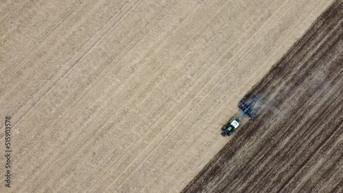 Plowing a wheat field during a very dry summer season - aerial view