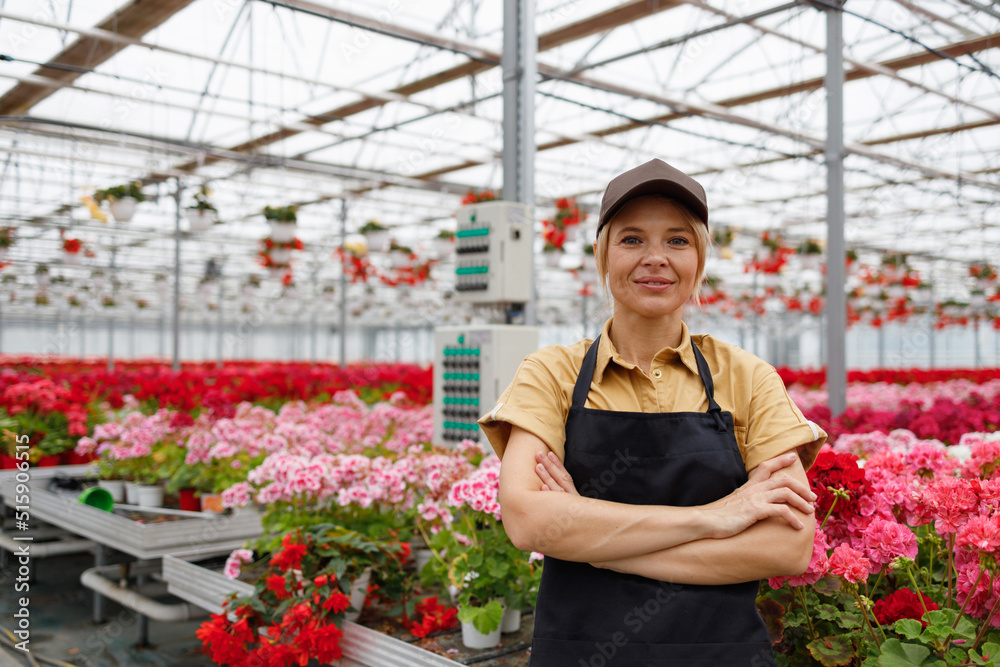 Portrait of confident florist in greenhouse