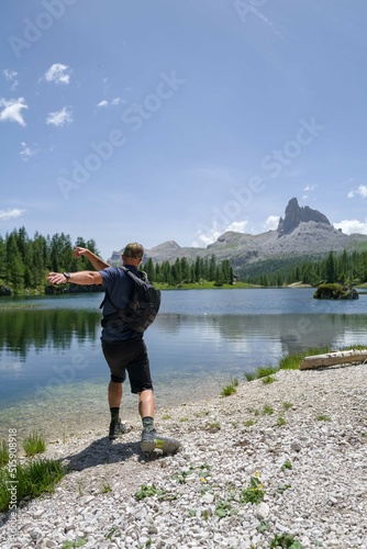 Man throwing stone in the water in the lake