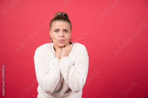 A young woman holding throat and suffering from pain © azerbaijan-stockers