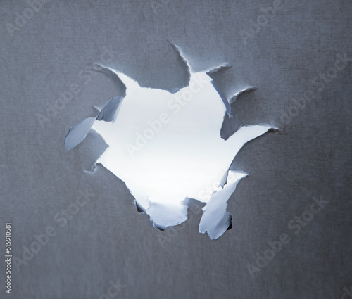 Hole punched in a paper sheet photo