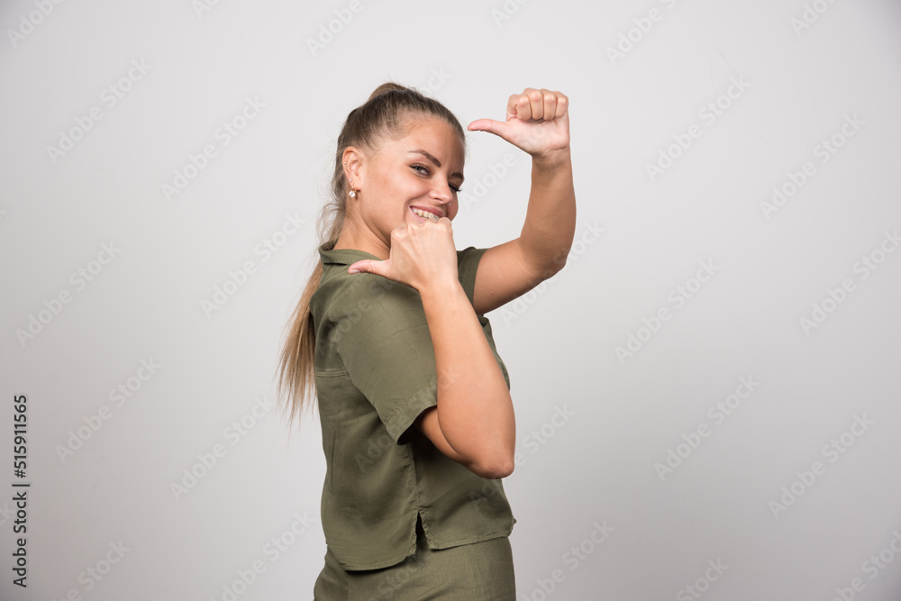 Beautiful woman in green jacket giving thumbs up Beautiful woman in green jacket giving thumbs up