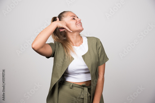 Young woman in white shirt calling someone
