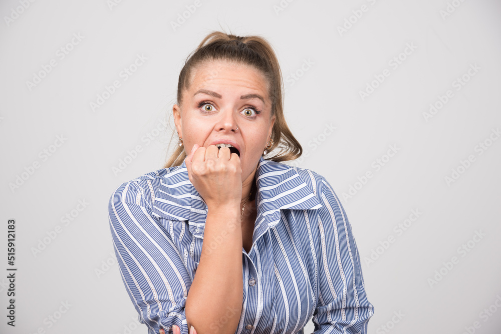 Portrait of woman feeling angry on gray background Portrait of woman feeling angry on gray background