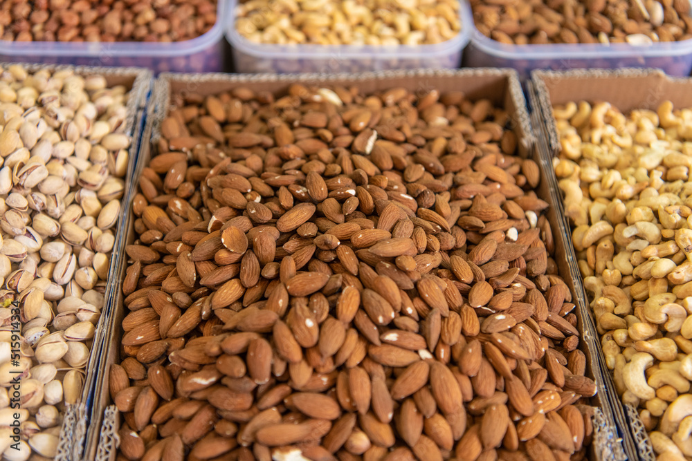 Pile of assorted nuts almonds, pistachio, cashew at street market. Organic mixed nuts background. Healthy food. Pile of assorted nuts almonds, pistachio, cashew at street market. Organic mixed nuts background. Healthy food.
