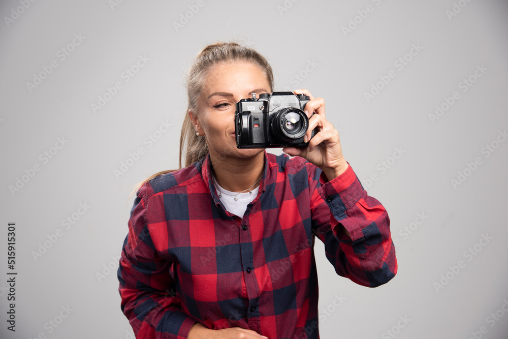 Blonde photograph in checked shirt takes photos as a professional Blonde photograph in checked shirt takes photos as a professional
