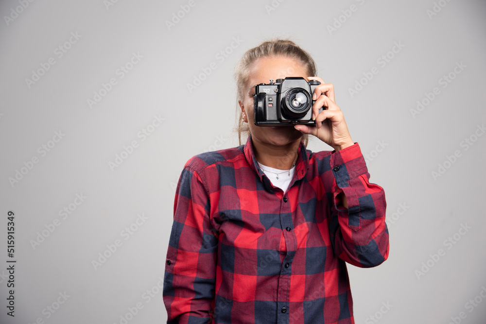 Blonde photograph in checked shirt takes photos as a professional Blonde photograph in checked shirt takes photos as a professional