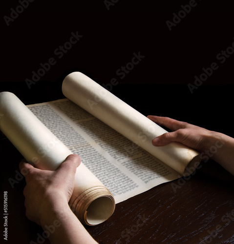 Hands holding an ancient scroll