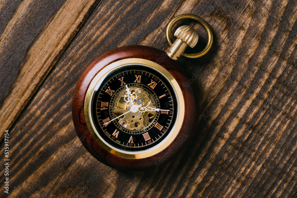 Old pocket watch on wood
