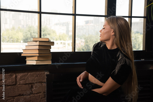Young woman posing and looking on window with books Free Download Young woman posing and looking on window with books - GFXLoad