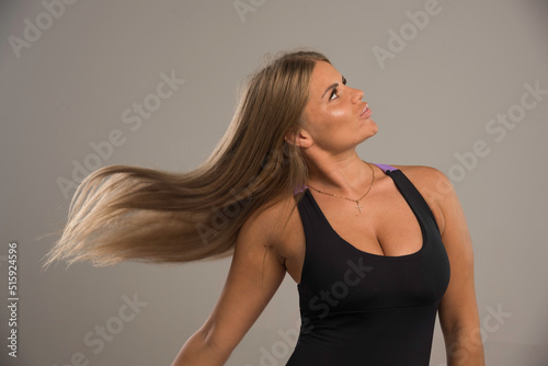 Female model in sport bra blowing her hairs