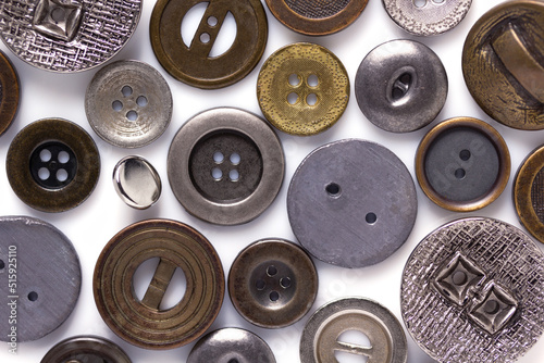 Old button isolated at white background. Aged buttons collection closeup