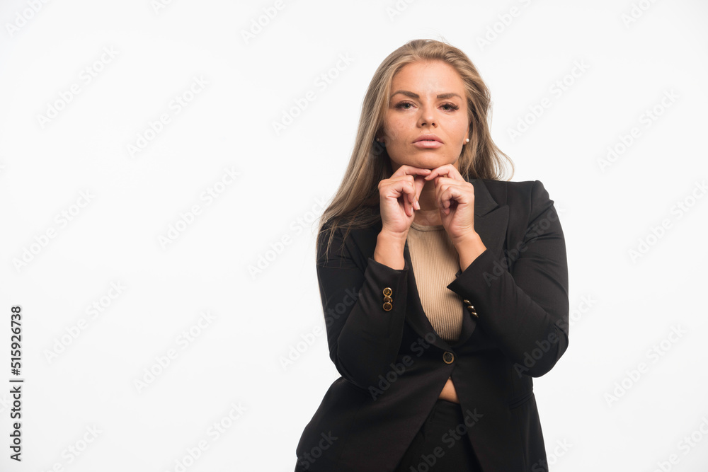 Young businesswoman in black suit looks dedicated Young businesswoman in black suit looks dedicated