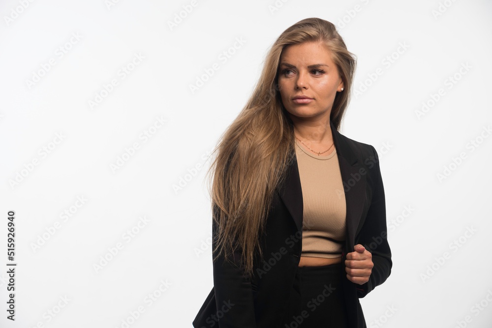 Young businesswoman in black suit looks confident and professional Young businesswoman in black suit looks confident and professional