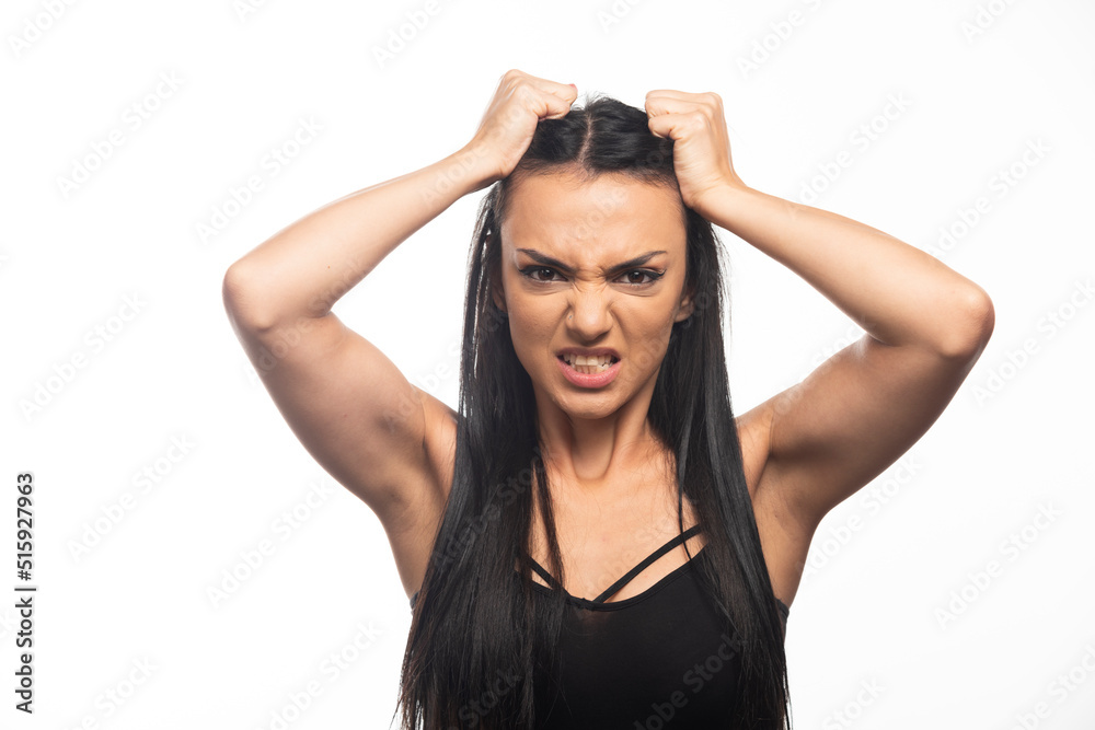 Portrait of young woman posing on white background