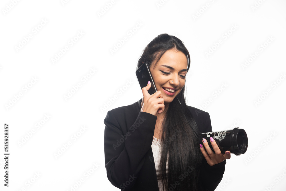 Business woman talking on cellphone on white background