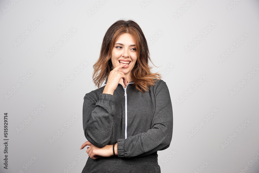 Portrait of a beautiful young woman standing and thinking Portrait of a beautiful young woman standing and thinking