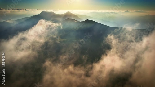 Flying through the clouds and above the mountains, epic natural landscape  photo