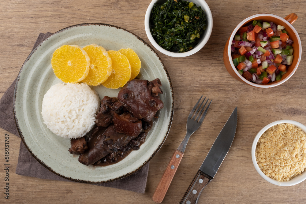 Typical Brazilian food feijoada, vinaigrette, toasted manioc flour and green cabbage.. Typical Brazilian food feijoada, vinaigrette, toasted manioc flour and green cabbage..