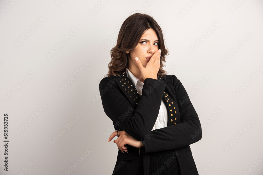 Female employee covering her mouth because of sudden news Female employee covering her mouth because of sudden news