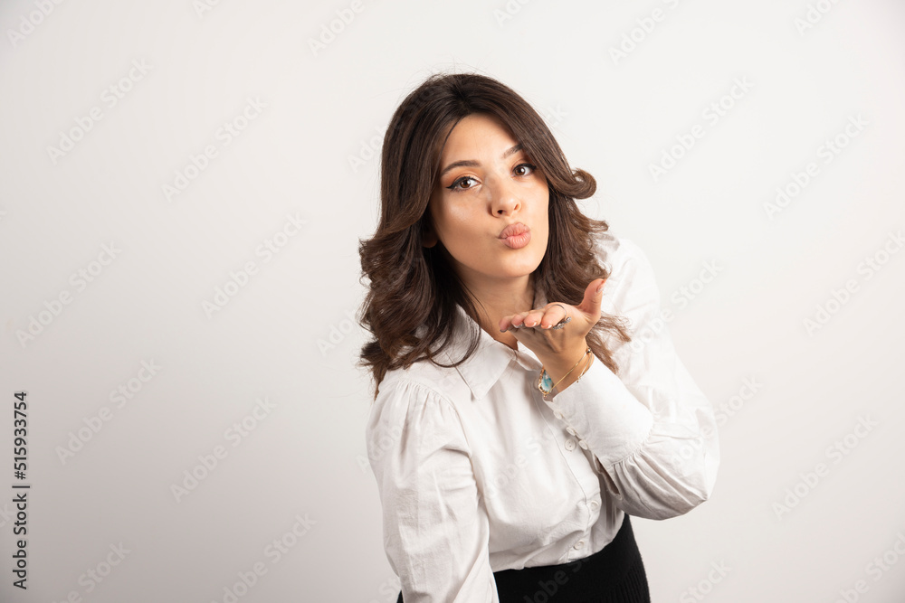 Woman employee blowing kiss on white background Woman employee blowing kiss on white background