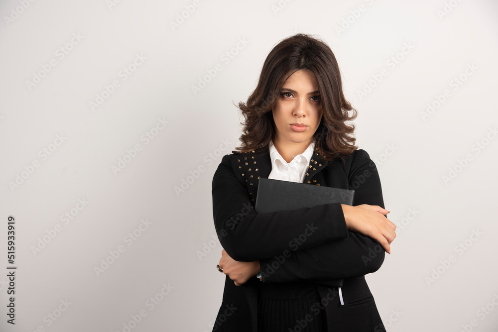 Serious looking teacher standing on white background Serious looking teacher standing on white background
